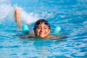 Young boy swimming in a swimming pool