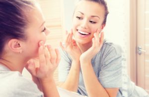 Woman looking in the mirror experienced tmj releif with Botox in Fort Collins